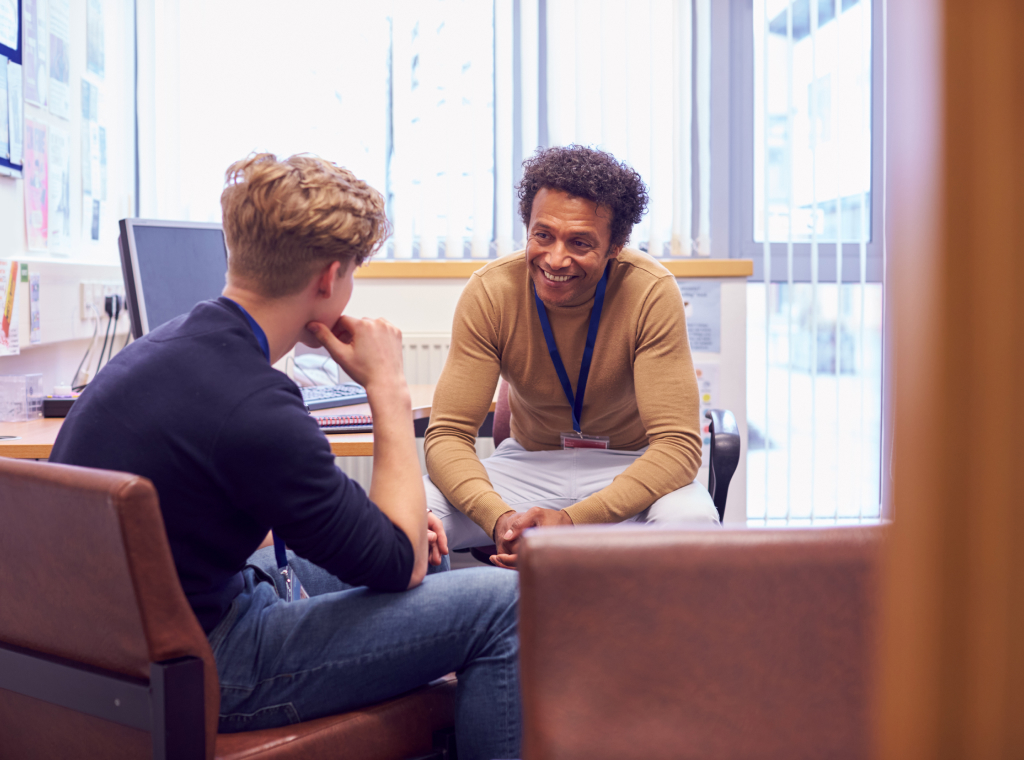 A college student talks to a staff member about their the opportunities available to them.